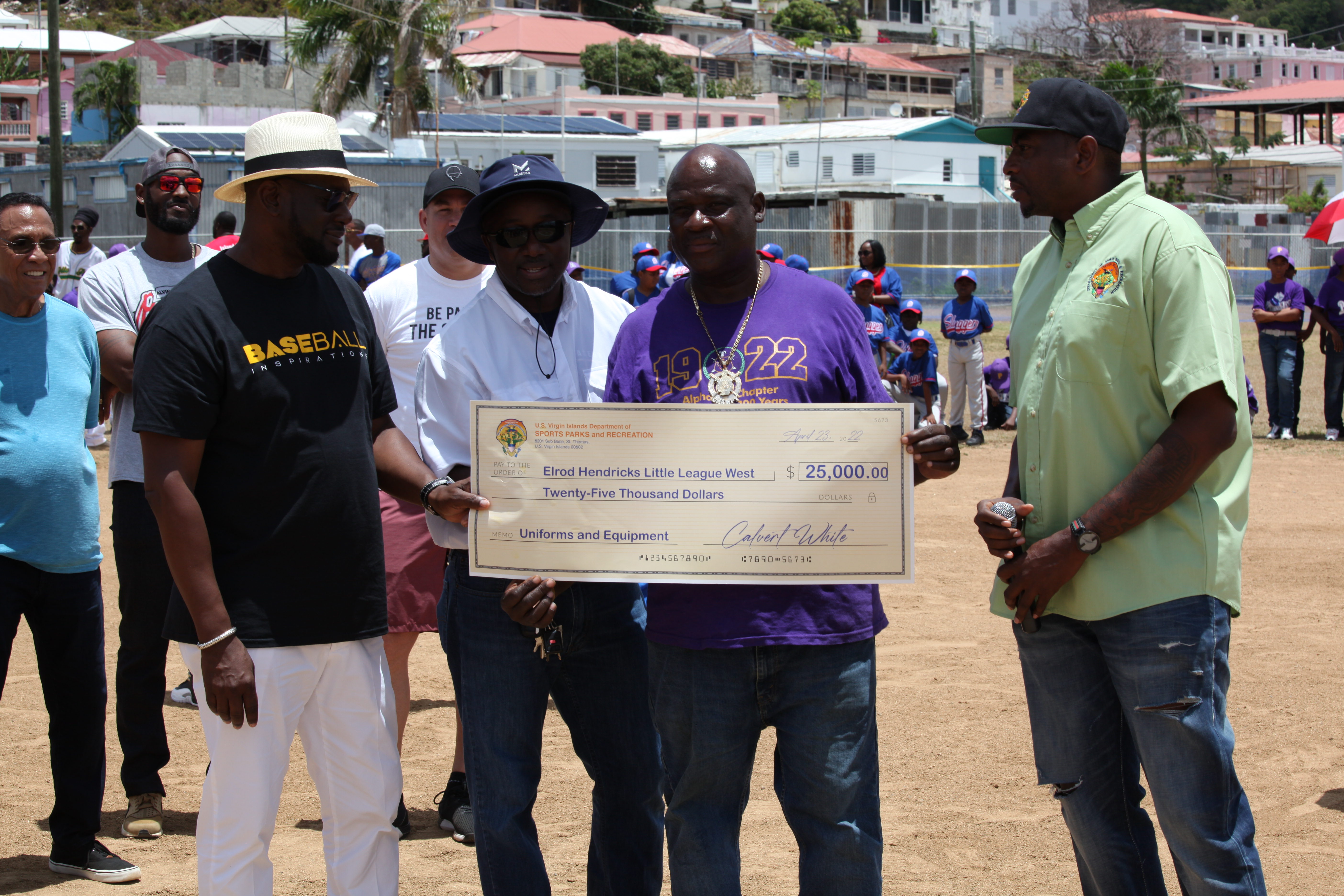 Community leaders present a ceremonial check during Little League opening ceremonies at Griffith Ballpark.