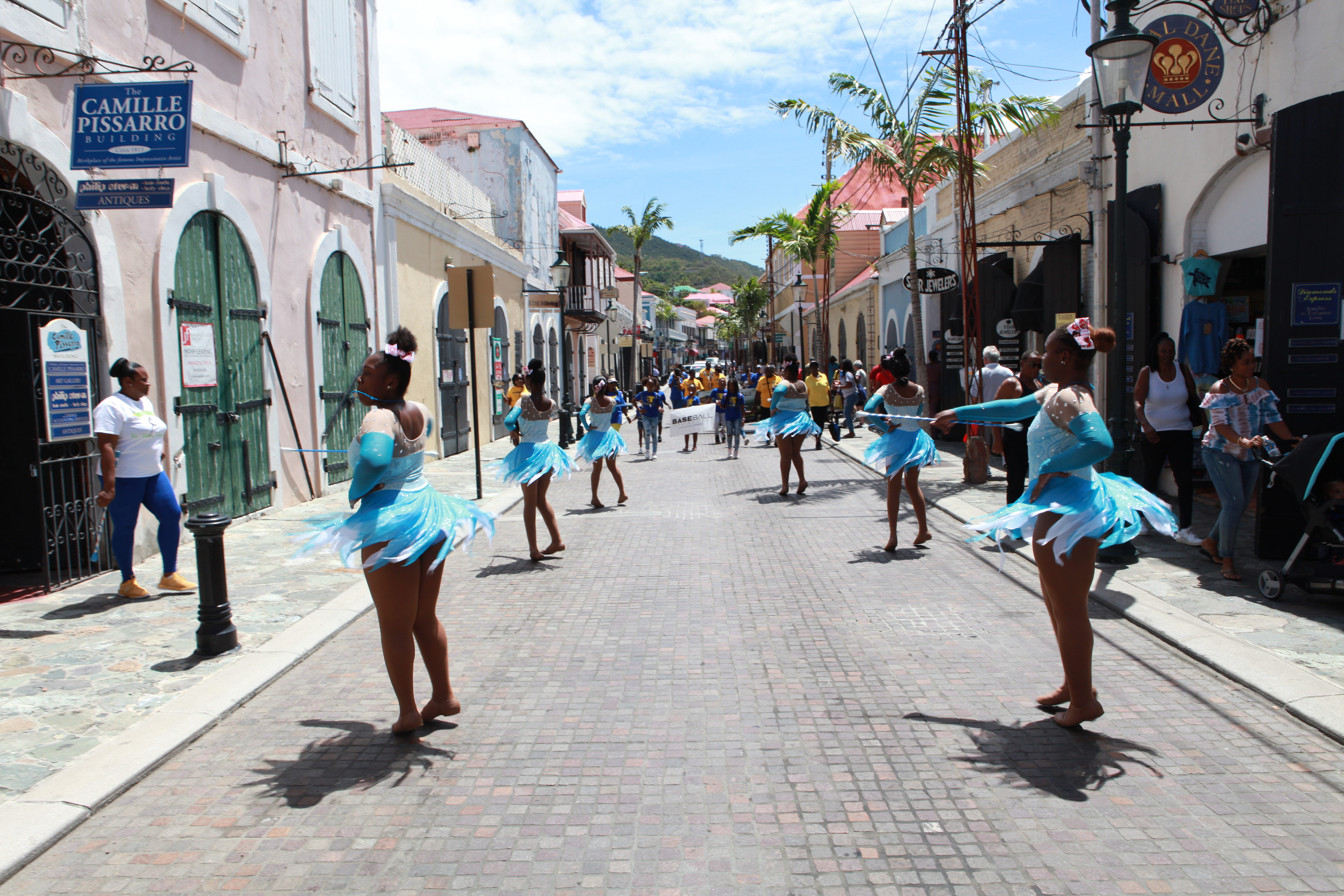 Opening day parade participants move down a St. Thomas street before Little League ceremonies.