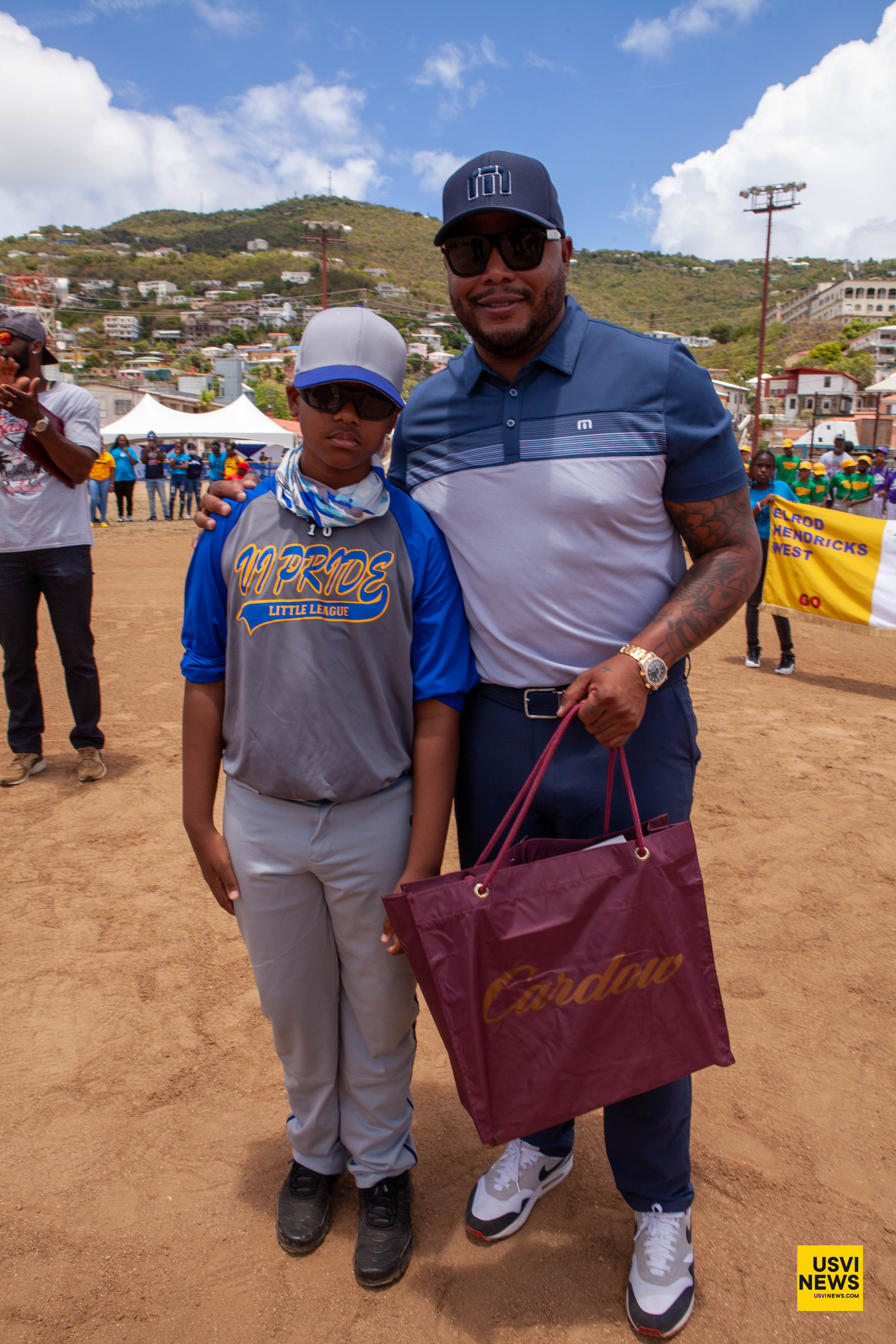 Andruw Jones poses with a young player during St. Thomas Little League opening day.