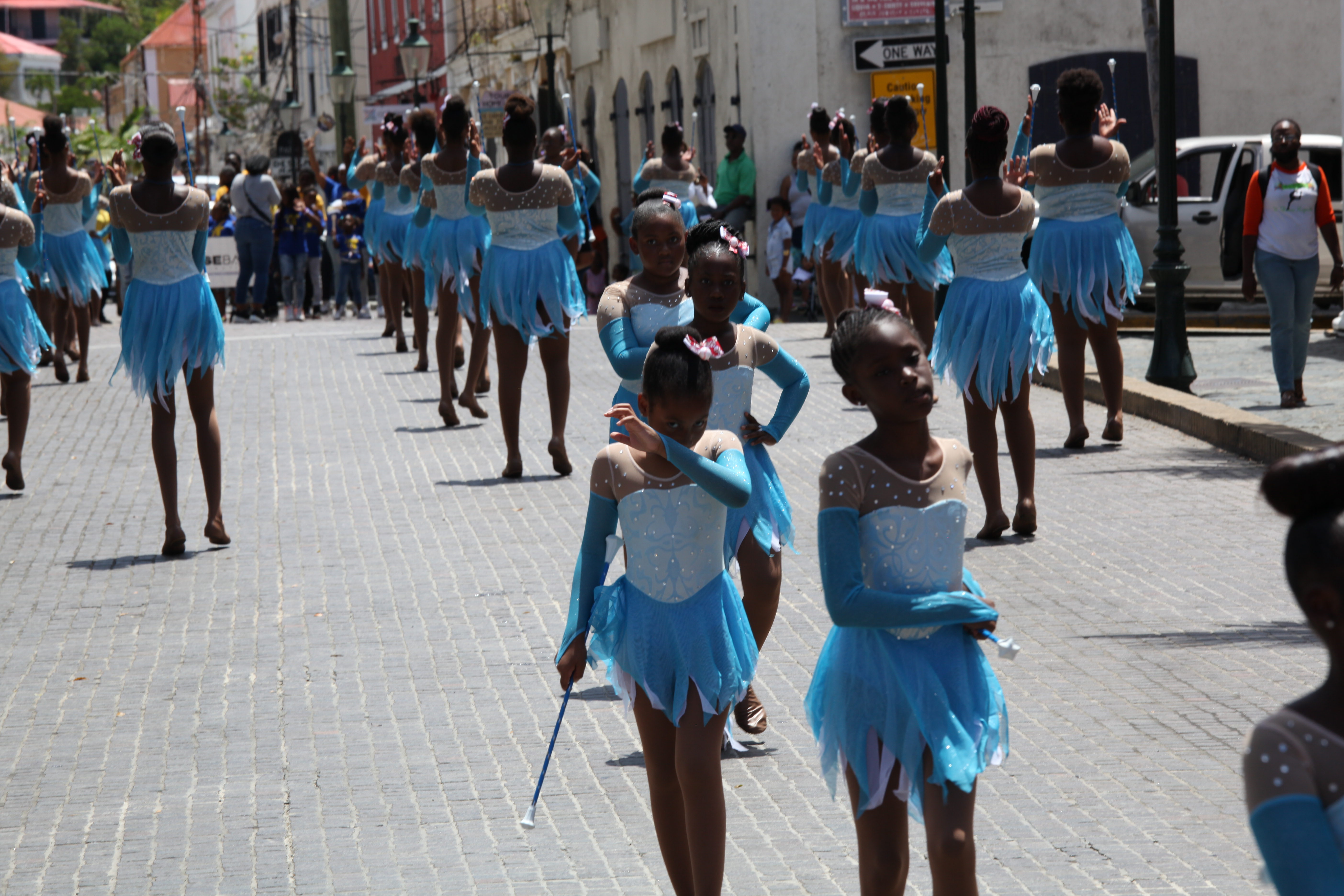 A line of dancers performs in downtown St. Thomas during the Little League opening day parade.
