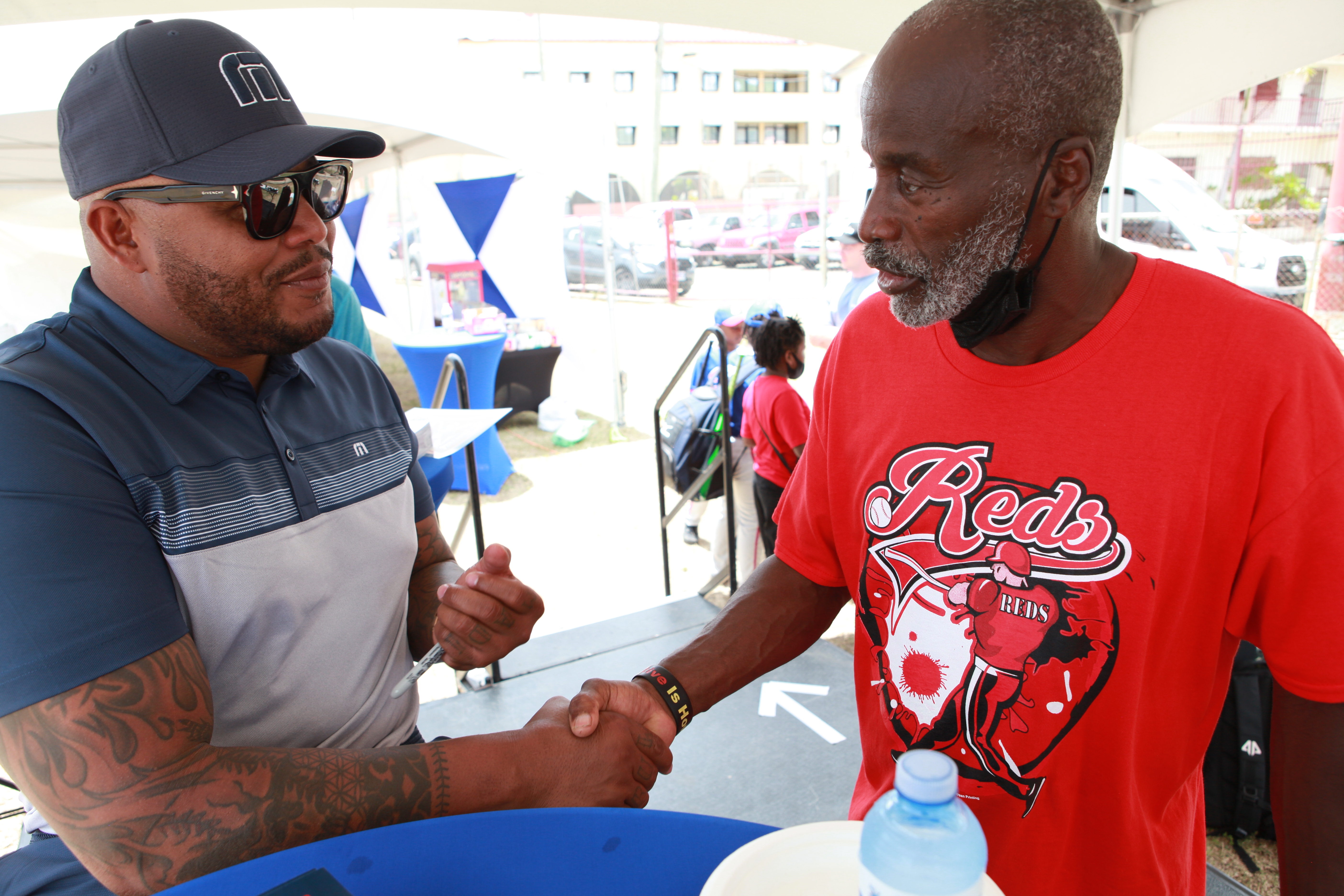 Andruw Jones greets a young fan at the autograph table during Little League opening day in St. Thomas.