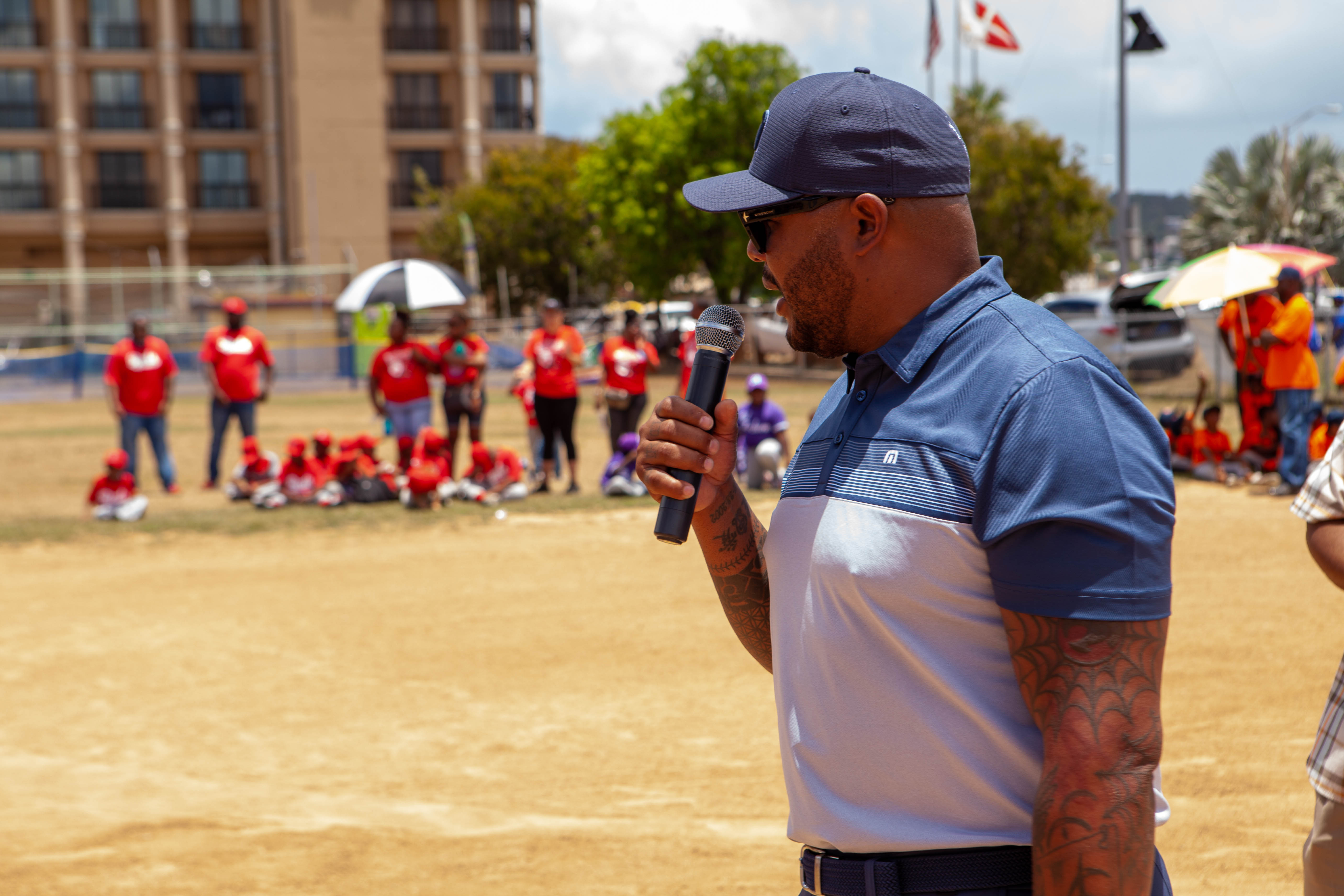 Andruw Jones speaks into a microphone on the field.