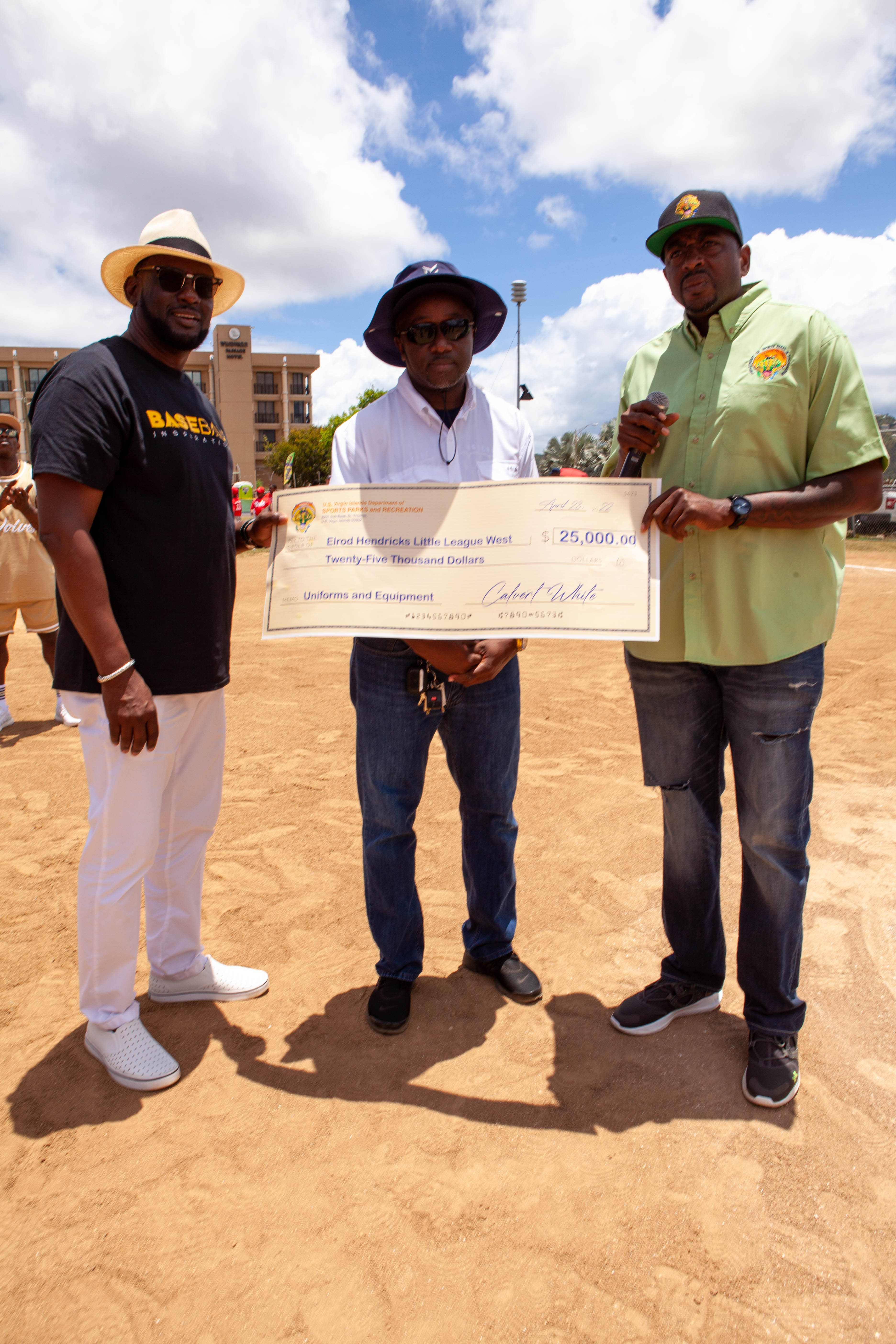 Calvert White stands with two men holding a ceremonial check.
