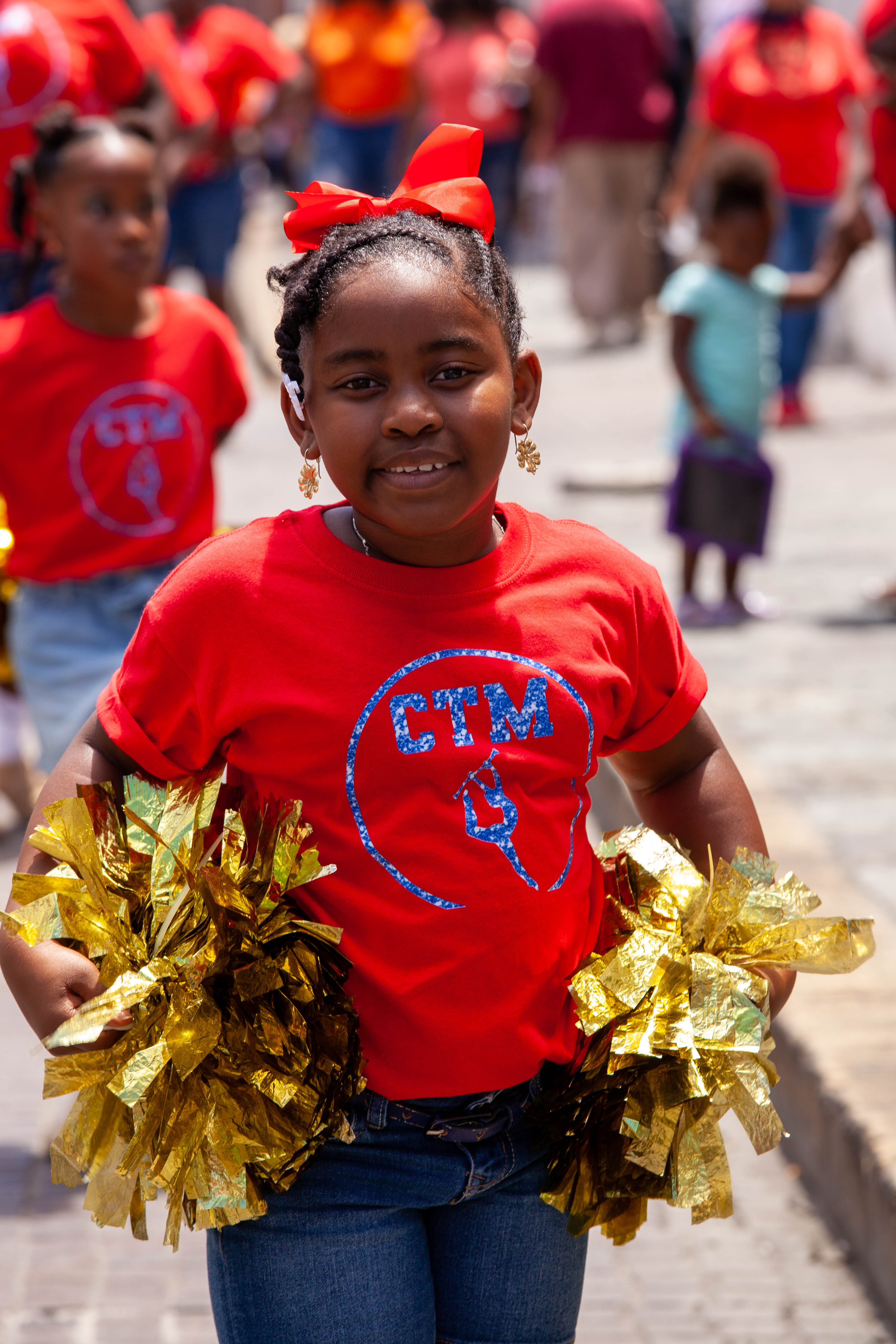 Blue-uniformed youth players walk together during the Little League parade in St. Thomas.