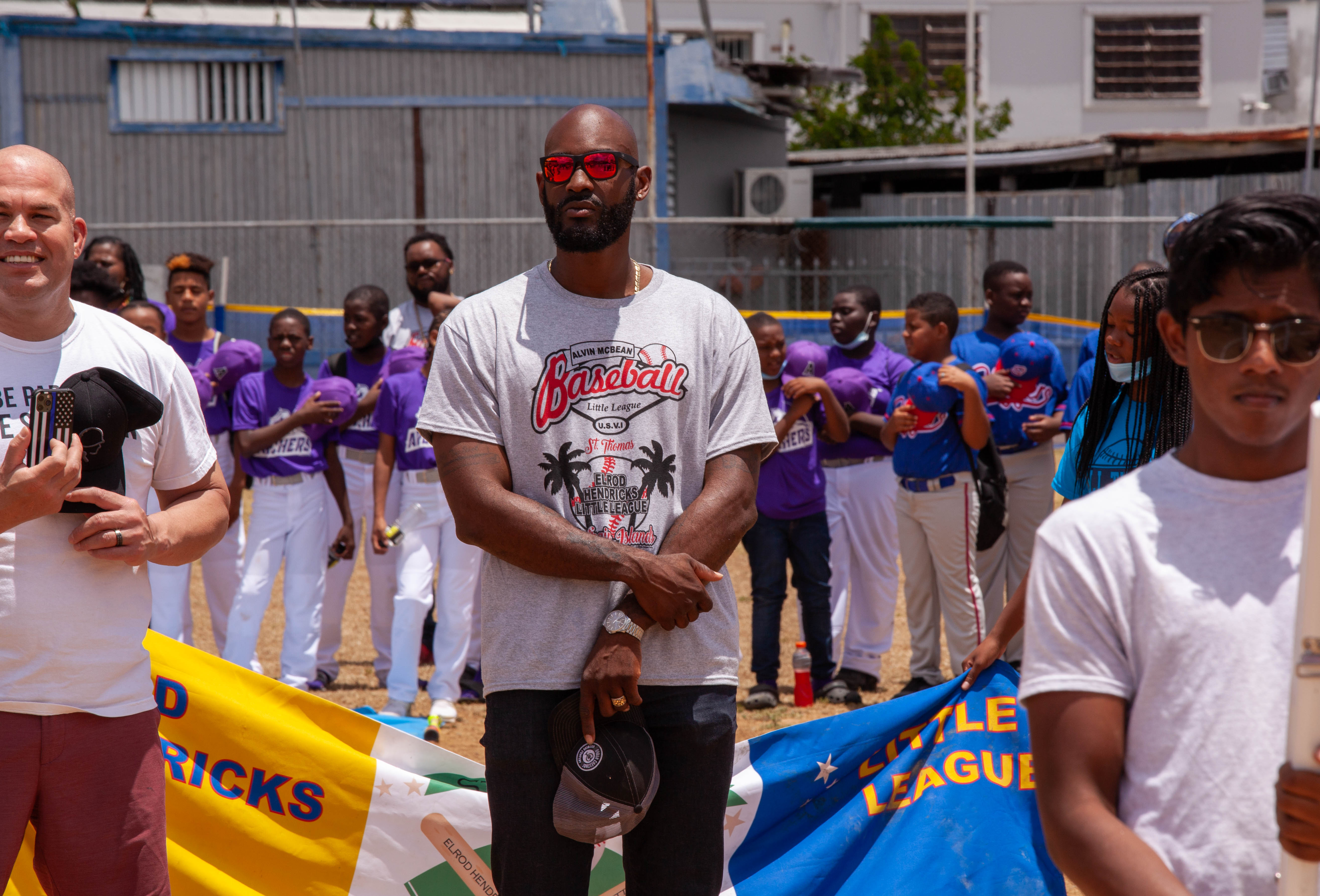 Supporters gather along the field as Little League opening day continues in St. Thomas.