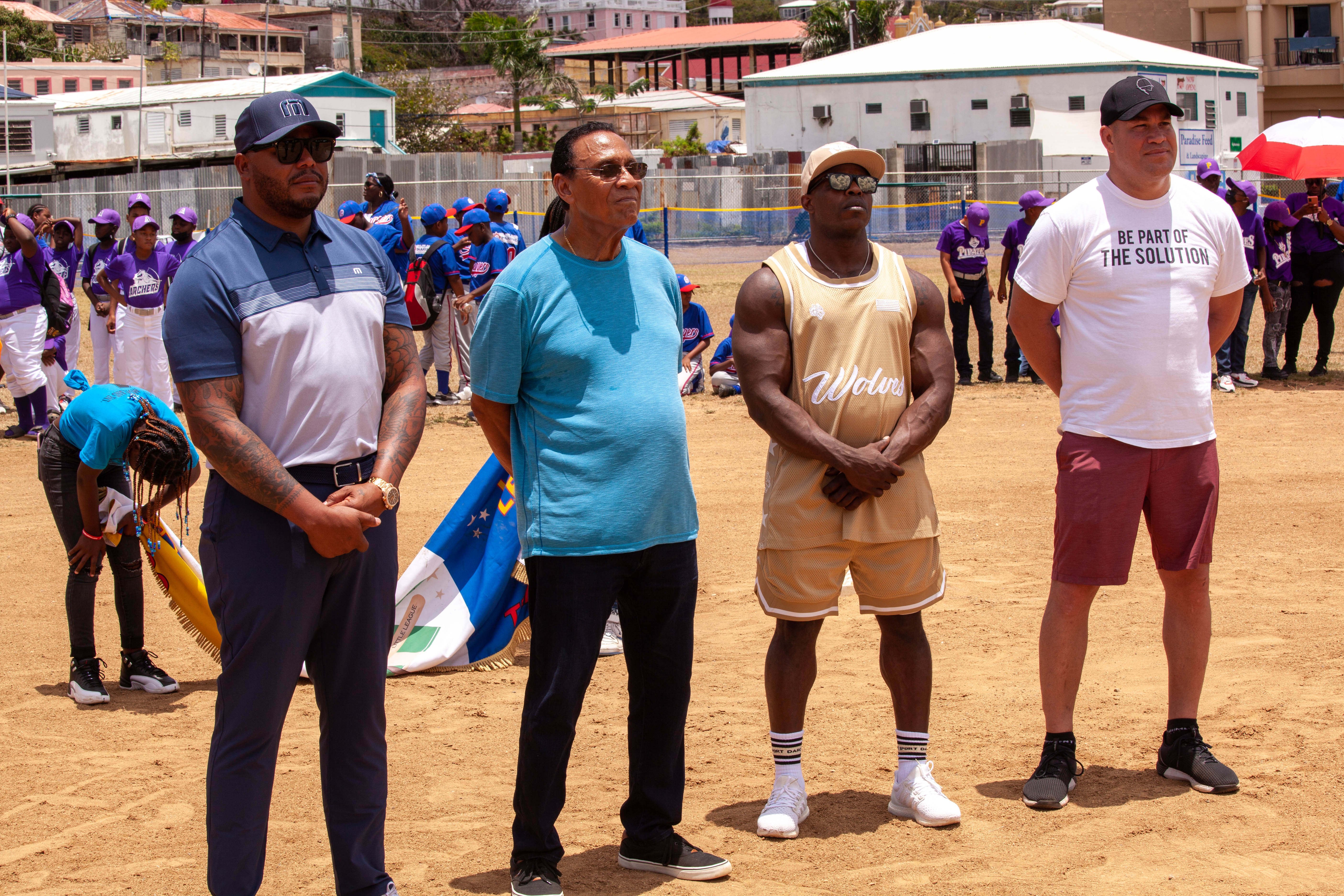 Tony Perez stands with other guests on the field during opening ceremonies.