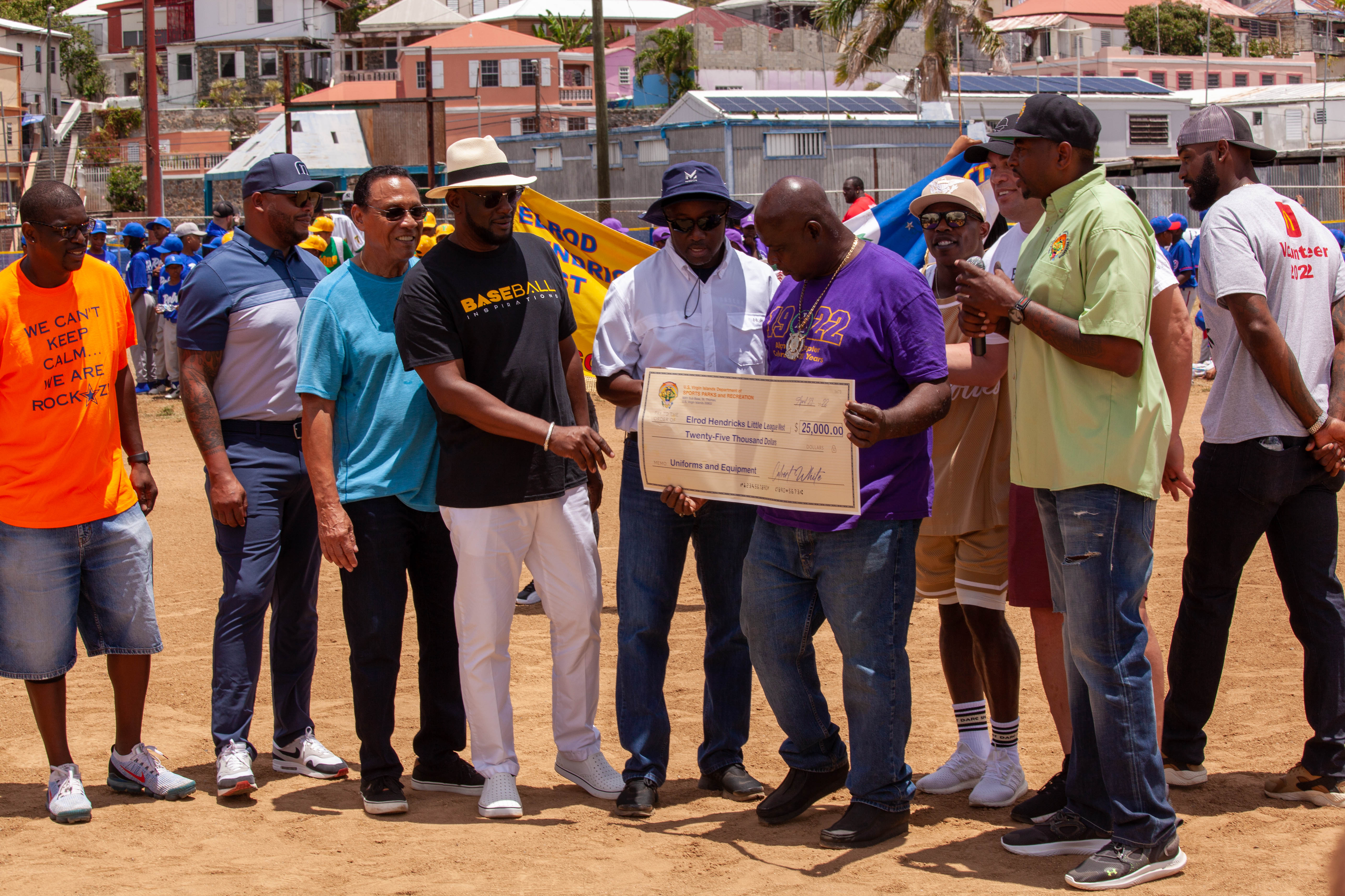 Tony Perez and other guests gather for a ceremonial check presentation.