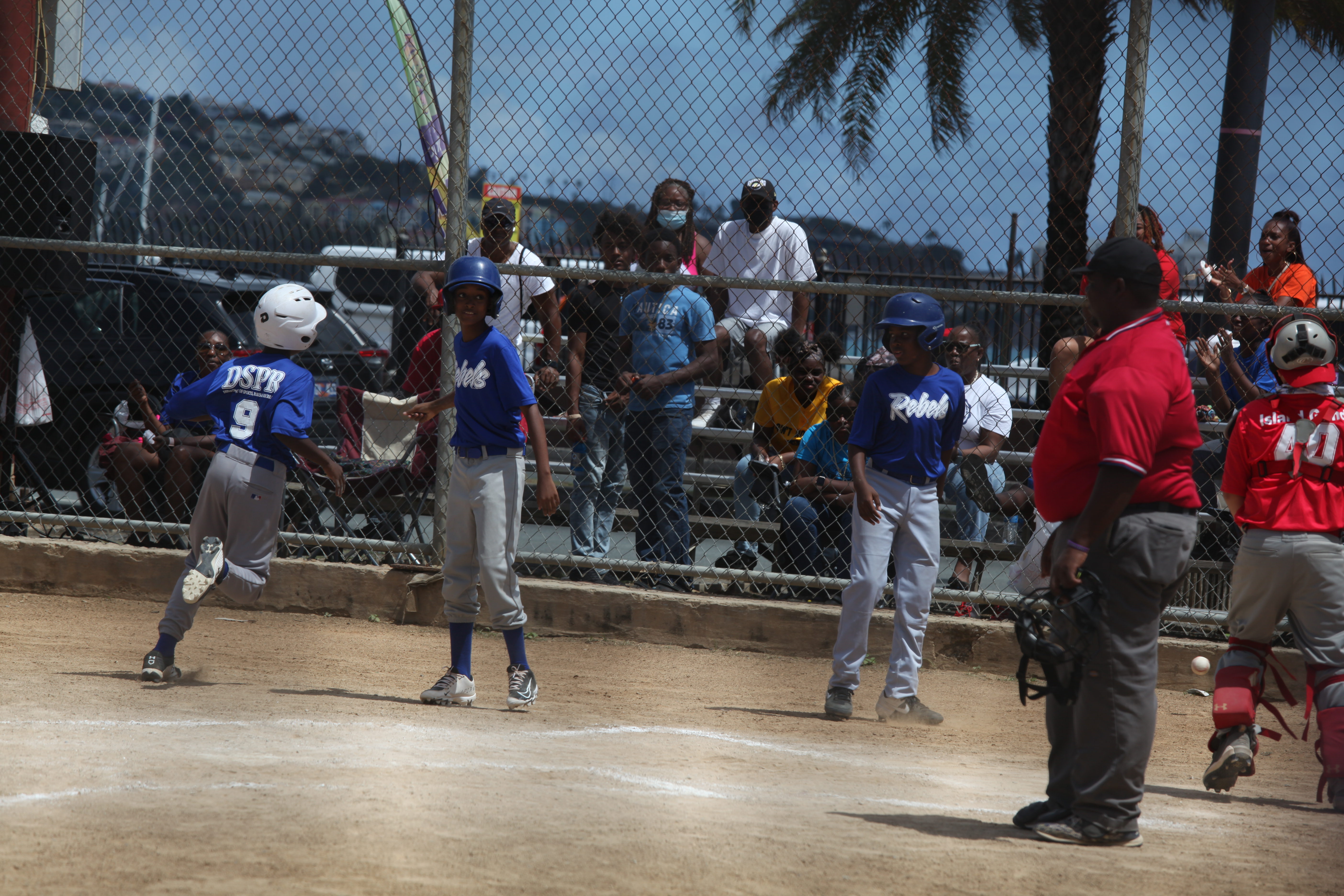 A young pitcher works from the mound as Little League play continues in St. Thomas.