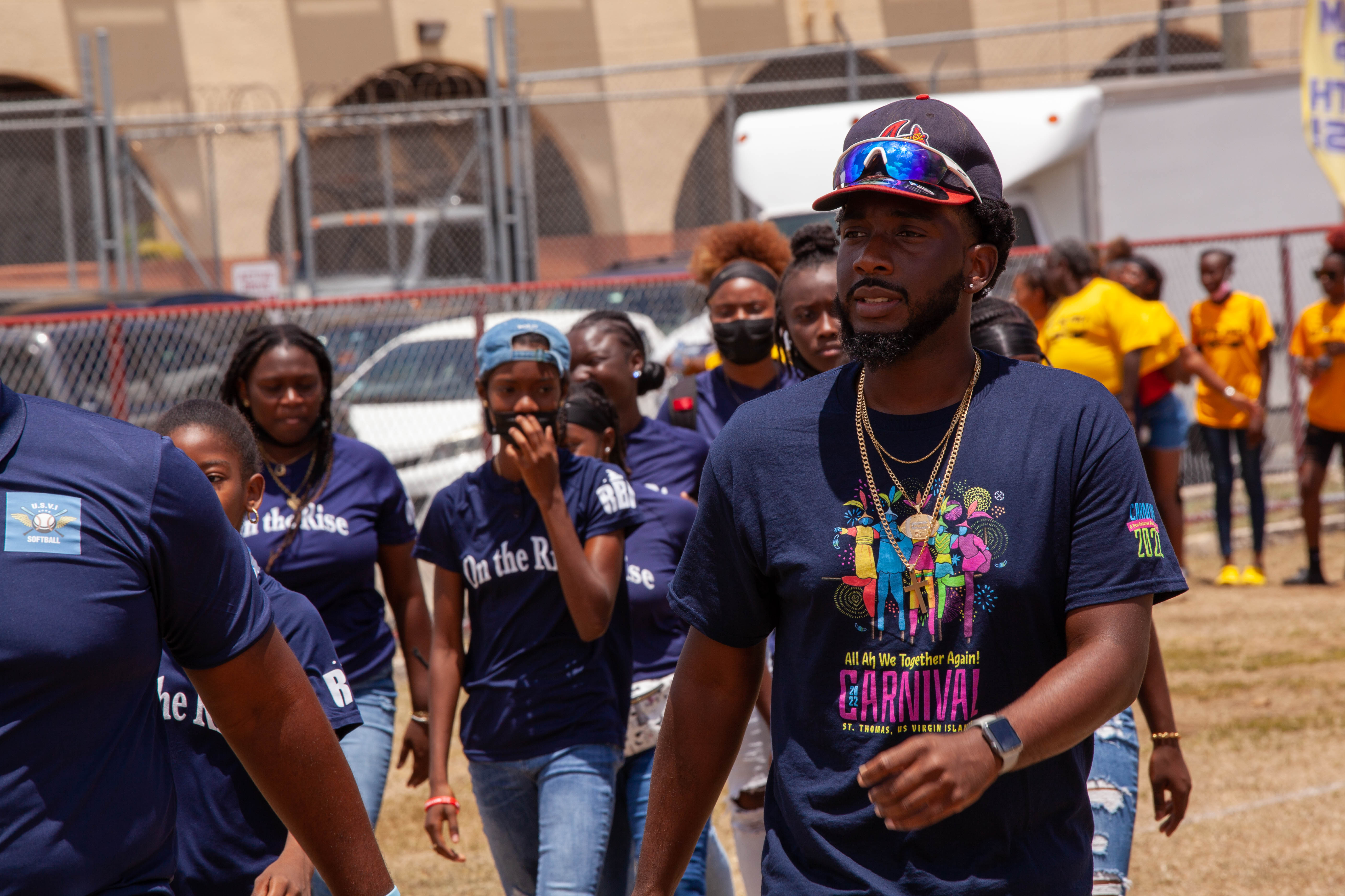 Families and spectators watch the Little League opening day program at Griffith Ballpark.