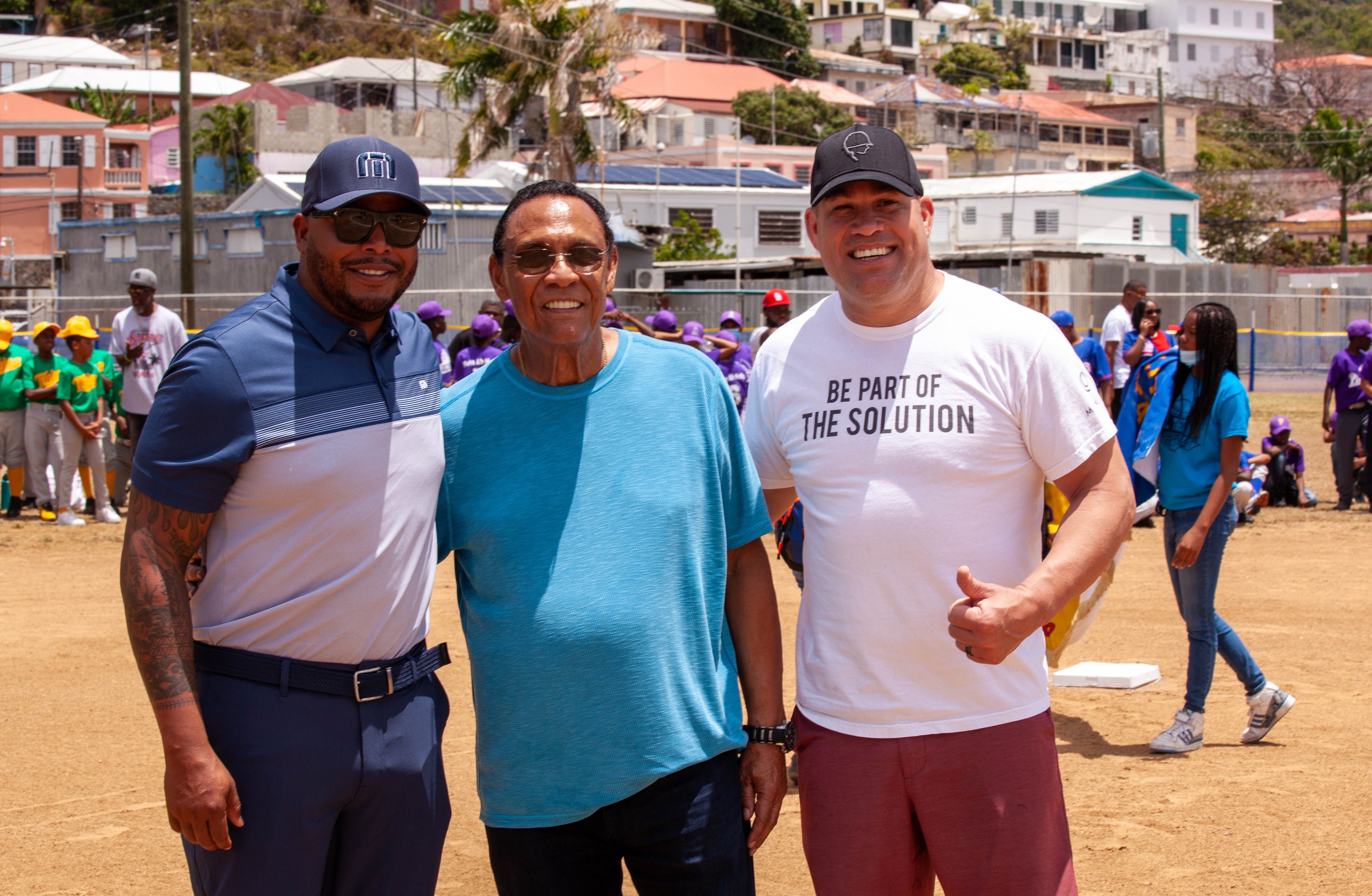 Tony Perez poses with other guests on the baseball field.