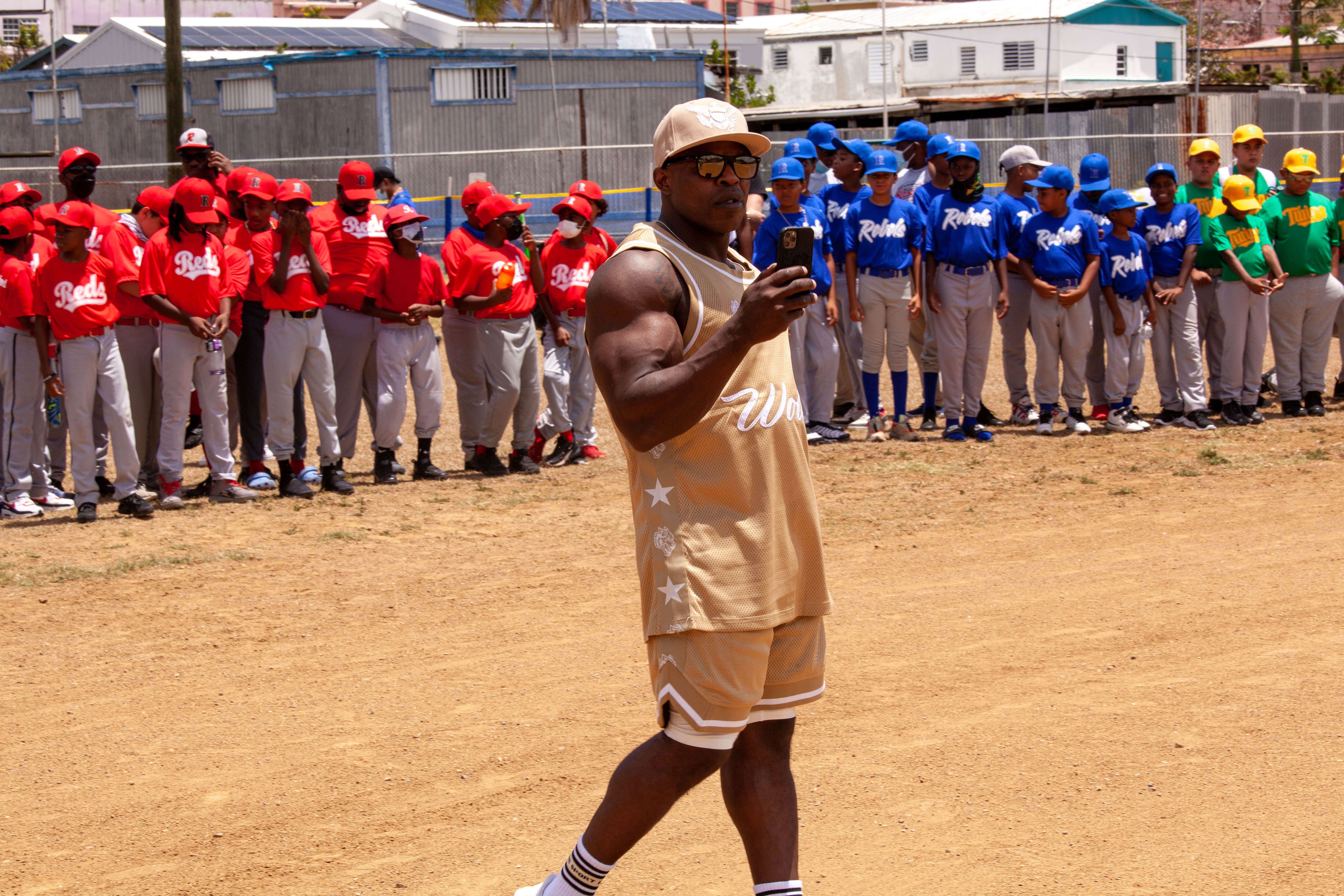 Andre Ferguson speaks on the field before lined up youth teams.
